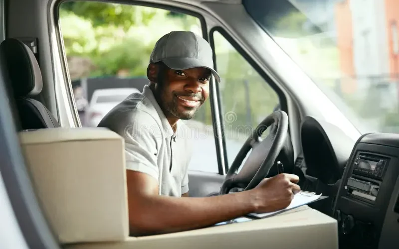 courier-delivery-black-man-driver-driving-car-boxes-packages-high-resolution-124918588 courier-delivery-black-man-driver-driving-car-boxes-packages-high-resolution-124918588